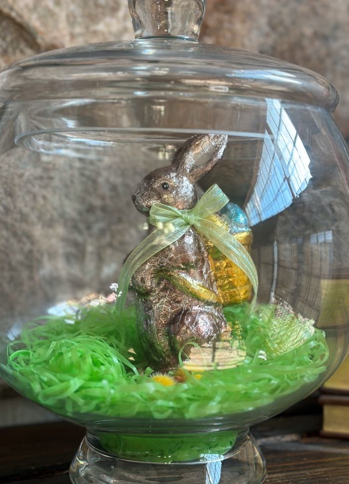 A fake chocolate bunny in an apothecary jar.