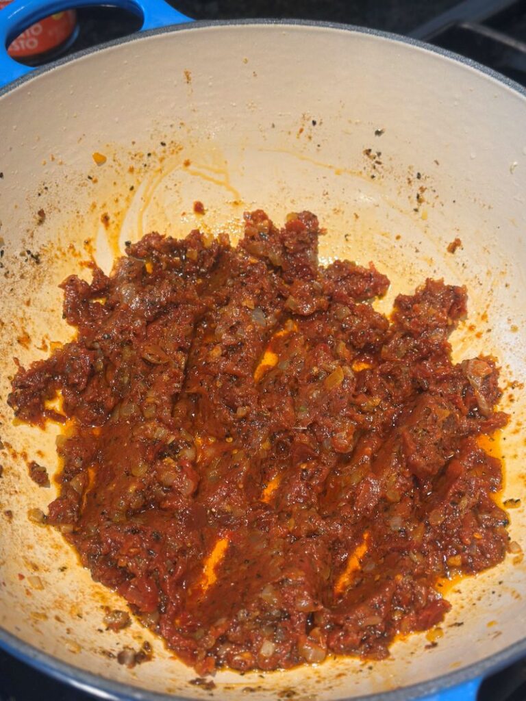 After adding the tomato paste to the sauce in the pot.