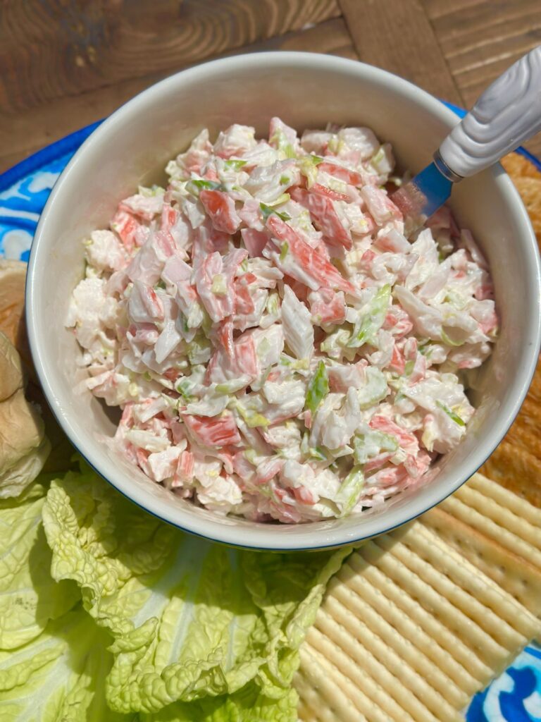 Easy Crab Salad With Crackers, Rolls, and More on a Serving Platter