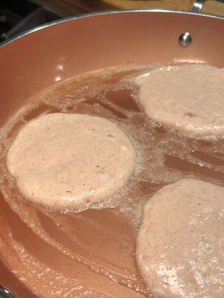 Cooking the Pancakes in a Large Copper Colored Skillet