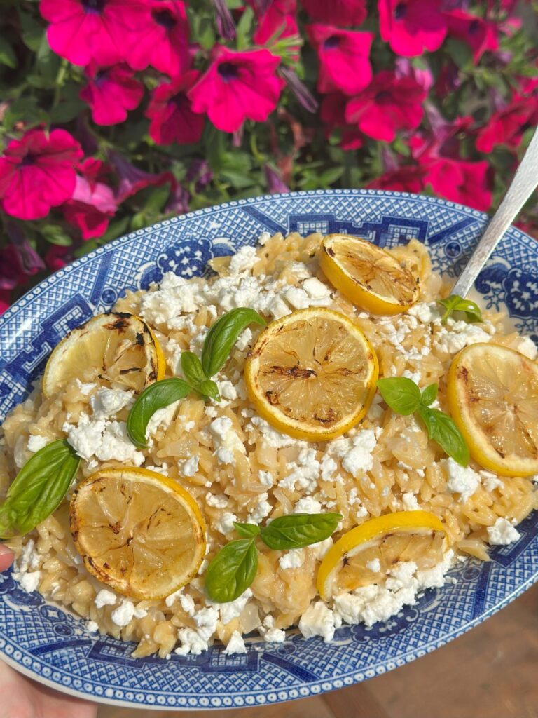 Creamy Lemon Orzo With Feta In Front of Flowers