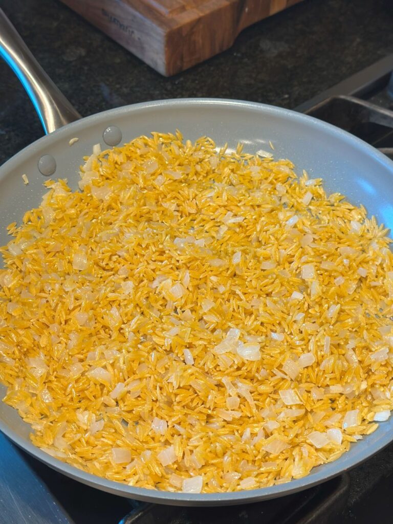 Toasting the orzo in butter.