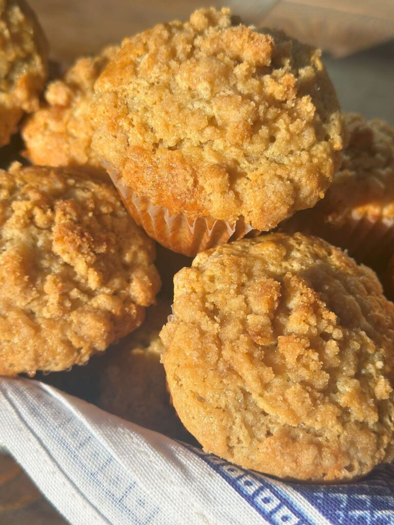 A basket of banana muffins piled on top of each other.